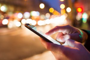 close up of male hands nightlight smartphone